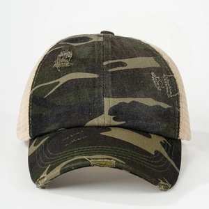 Detailed view of camouflage trucker hat with distressed brim and breathable beige mesh