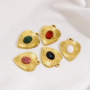 Vintage gold heart pendants set with colorful natural stones and embossed metal textures