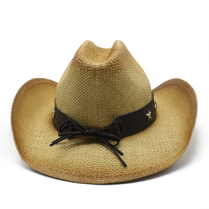 Detailed macro of a woven straw cowboy hat featuring a leather band with silver star studs