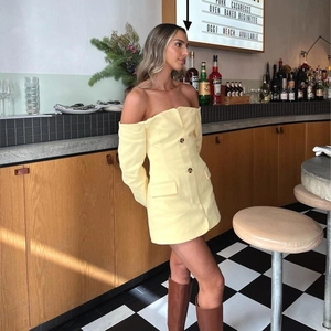 Detail view of a yellow off-shoulder long sleeve dress with stylish front buttons