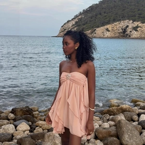 Pink halter backless floral mini dress with starfish accent and ruffled hemline