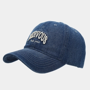 Macro detail of 3D embroidery and washed denim texture on a vintage baseball cap