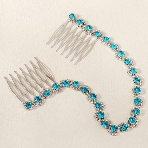 Detail of silver bridal hair comb with blue crystal rhinestones and linking chain