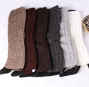 Flat lay of knit leg warmers in various colors including khaki, grey, and cream