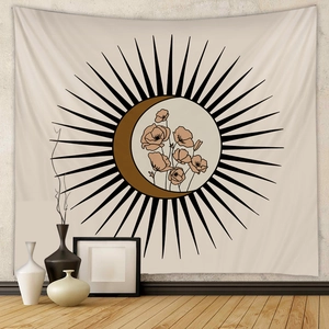 Detail of bohemian sun and crescent moon tapestry hanging on a textured bedroom wall