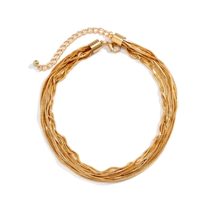 Detail of layered gold metal braided bracelet with adjustable lobster clasp and extension chain