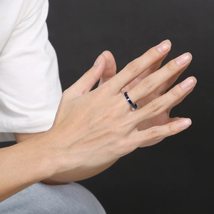 Detail of a 3mm navy blue minimalist stainless steel ring on a model hand