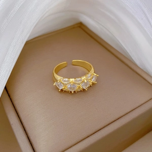 Macro detail of gold plated square zircon adjustable ring on brown leather case