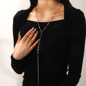 Adjustable Y-shaped gold chain necklace with colorful round crystals on a female model