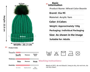 Detail showing dimensions and material of green knit beanie with faux fur pom-pom