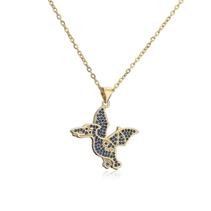 Detailed shot of golden pterosaur pendant set with sparkling blue zircons on O-chain