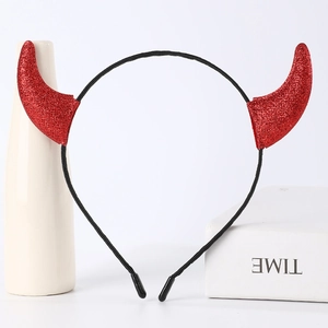 Detailed view of a red glittery devil horn headband for Halloween costumes