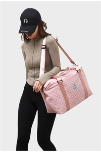 Detail of pink quilted yoga bag with wide straps and adjustable shoulder strap