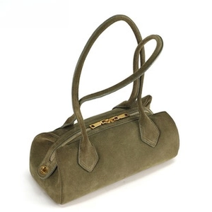 Detail view of dark green suede barrel handbag with premium gold dual zippers and long straps