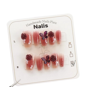 Handmade press-on nails with camellia flowers, glitter butterflies, and pearl accents