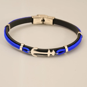 Detail of nautical anchor bracelet featuring blue woven rope and black leather band