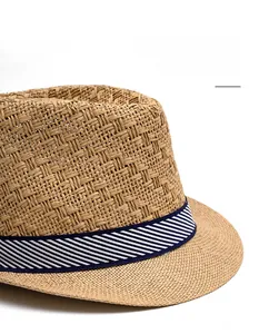 Close-up of breathable straw sun hat featuring a classic blue and white striped band