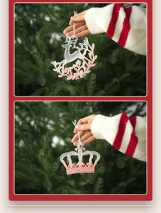 Pink frosted reindeer and crown ornaments hanging on a Christmas tree branch