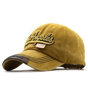 Close-up of vintage yellow baseball cap with Los Angeles 3D embroidery and leather brim