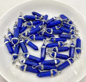 Bulk natural lapis lazuli hexagonal point pendants displayed on white ceramic plate