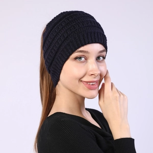 Macro shot of dark blue knitted headband with textured chunky cable knit patterns