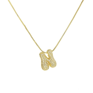 Close-up of golden bubble letter N pendant with full zircon inlay on fine box chain