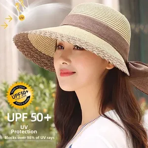 Detail view of woven straw sun hat with large bow and UPF 50+ sun protection