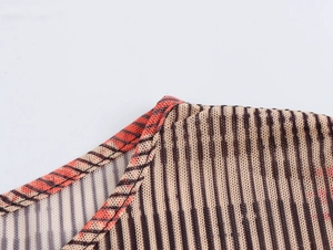 Détail du tissu en maille avec des rayures brunes et des coutures de précision