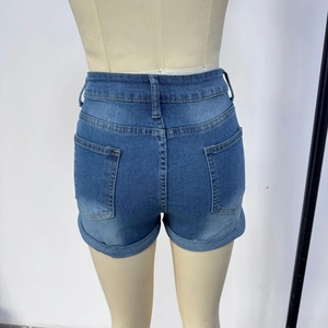 Detail of high-waisted blue denim shorts featuring double rear pockets and cuffed hems