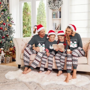 Family Christmas pajamas set with snowmen prints and Nordic pattern pants for holidays