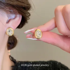 Elegant gold oval stud earrings with brushed texture and crystals for women