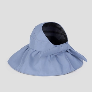 Detail of light blue sun hat with bow decoration and breathable black mesh lining
