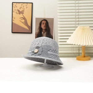 Elegant grey crochet sun hat with 3D flower and pearl on a display stand