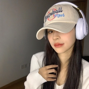 Beige baseball cap with Baseball Mom embroidery shown on a model for a stylish look