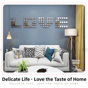 DIY silver acrylic mirror wall stickers forming LOVE text on a blue living room wall