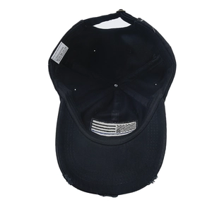 Detail view of cotton baseball cap with American flag patch and distressed brim design