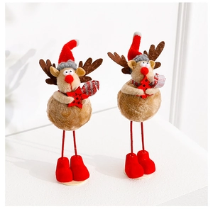 Detail of plush reindeer Christmas figures with red hats and boots on white background