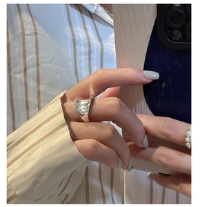 Close-up of a minimalist S925 sterling silver saddle ring worn on a hand