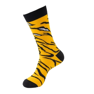 Detail of knit tiger stripe pattern on yellow cotton crew socks with black heel and toe