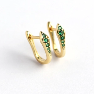 U-shaped gold snake earrings with green zirconia pavé on a clean white background