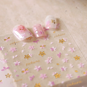 Pink and gold cherry blossom nail stickers with 3D embossed floral patterns and petal designs