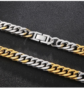Macro shot of two-tone gold and silver Cuban link chain with a secure folding clasp detail