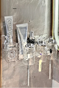 Detail view of wall-mounted toothbrush holder with automatic toothpaste dispenser