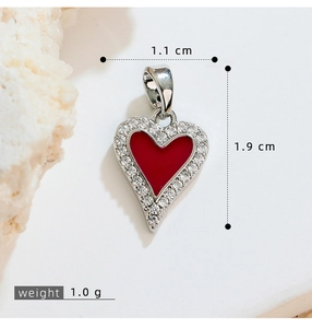 Detail shot of heart pendant with red enamel and clear stones, 1.1x1.9cm size