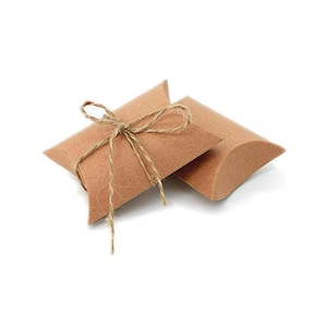 Close-up of brown kraft paper pillow boxes with decorative natural jute twine