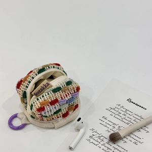 Detail of colorful knitted crochet pouch with zipper for wireless earbuds and small coins