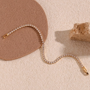 Minimalist 14K gold plated tennis bracelet with sparkling white zircons on textured stone