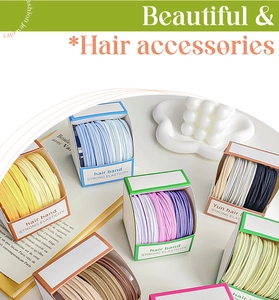 Close-up of assorted candy-colored elastic hair bands in organized gift packaging sets