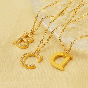 Gold titanium steel 26 letter pendant necklaces with crystal inlays on textured silk