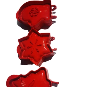 3-piece 3D Christmas cookie cutter set with tree, snowflake, and glove shapes in red